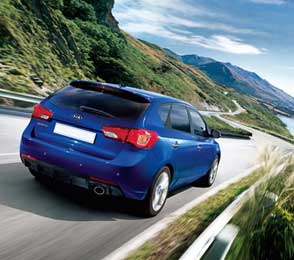 Blue Toyota Innova SUV driving on a winding mountain road illustrating taxi hire service options in Udaipur.